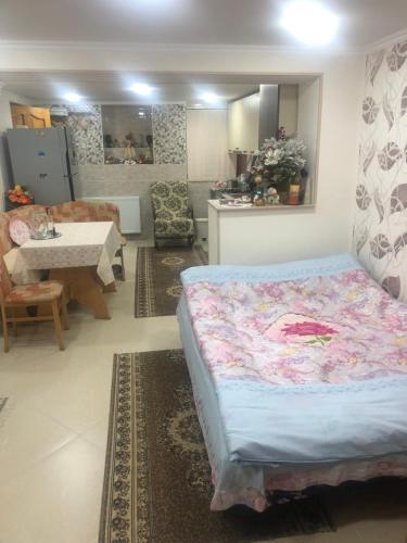 a bedroom with a bed and a living room at Hostel Temuri in Kutaisi