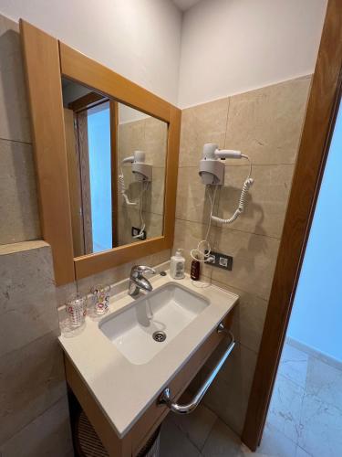 a bathroom with a sink and a mirror at Pearl Apartment Corralejo in Corralejo