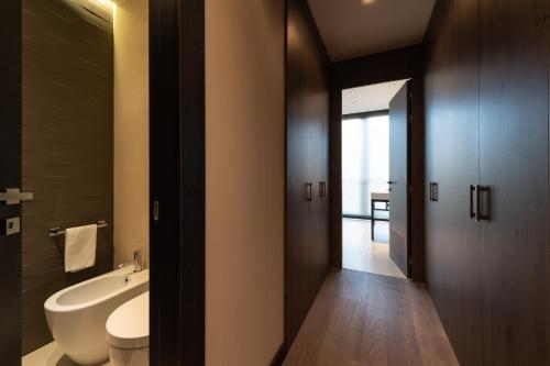 a bathroom with a tub and a toilet and a sink at Duparc Contemporary Suites in Turin