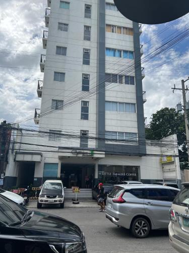 a building with cars parked in front of it at The Linds Condo Unit 814 Cityscape in Bacolod
