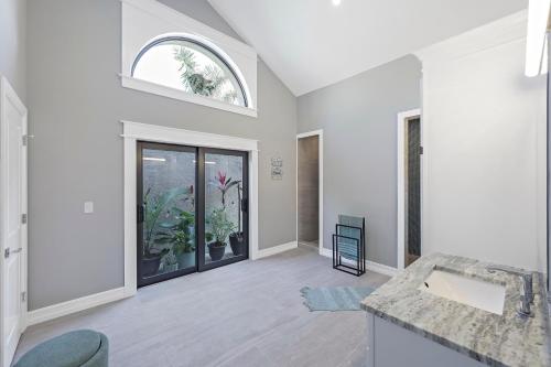 an empty living room with a sink and a window at Stunning home with pool, dock and direct gulf access in Marco Island