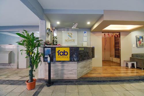 a lobby of a hotel with a sign on the counter at FabHotel Royce Studio Apartments in Pune