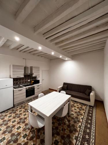 a living room with a white table and a couch at LB Home in Termini Imerese