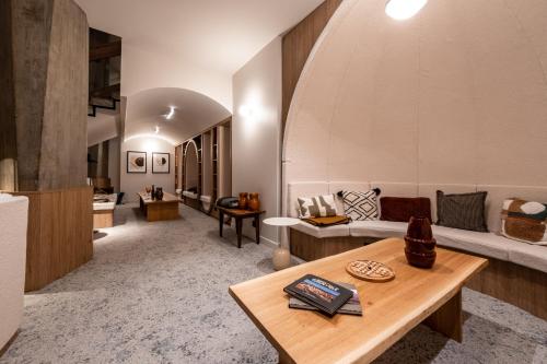 a living room with a couch and a table at Mercure Grenoble Centre Alpotel in Grenoble