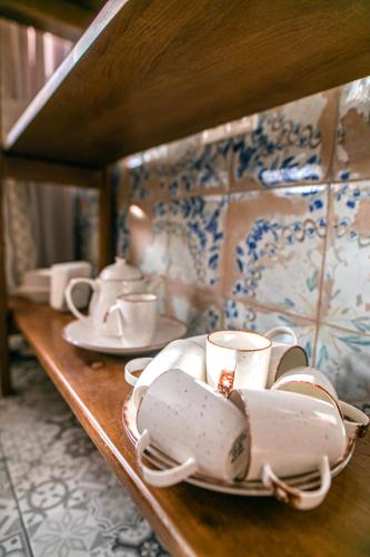 a shelf with cups and saucers on it at Котедж у Марка in Yaremche
