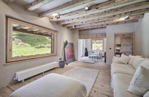 a living room with a couch and a window at Casa Pyrenees - Slow Life Refuge in La Molina
