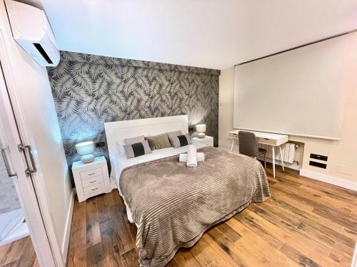 a small bedroom with a bed and a desk at Hideaway Plaza Mayor Salamanca in Salamanca