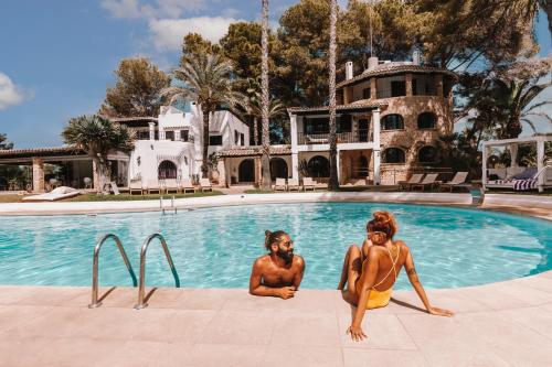 two naked women sitting in a swimming pool at Agroturismo Sa Talaia-Adults Only in San Antonio