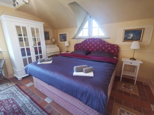 a bedroom with a bed with two towels on it at Vila Mirjam in Radovljica