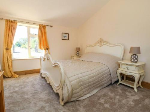 Un dormitorio con una gran cama blanca y una ventana en Charming 2-Bed Cottage in Otley en Otley