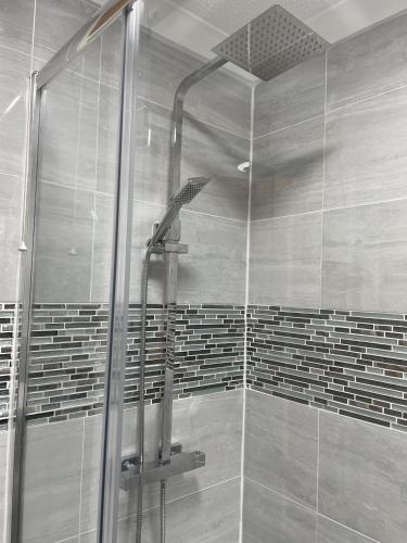 a shower in a bathroom with a glass door at Tivoli Bungalow in Weston-super-Mare