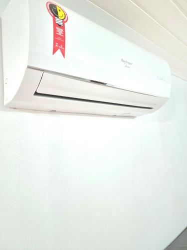 a white air conditioner hanging from a ceiling at Pousada do Primo in Capão da Canoa