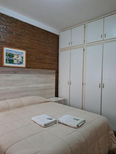 a bedroom with a bed with two towels on it at Terraza del Sol Apart in San Juan