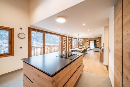 a kitchen with a large island in the middle of a room at Chalet Arande Saint Gervais - by EMERALD STAY in Saint-Gervais-les-Bains