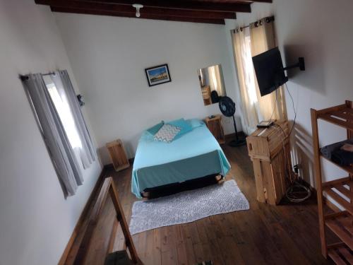 מיטה או מיטות בחדר ב-Quintal Residencial
