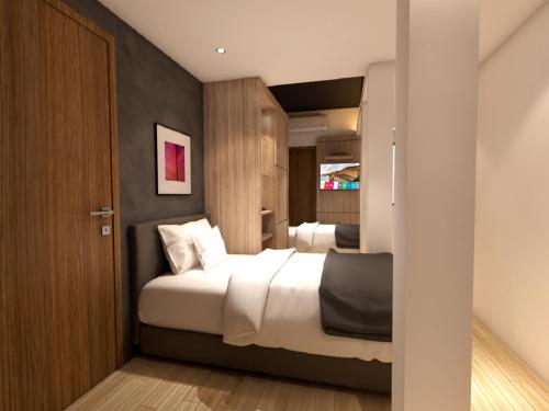 a hotel room with two beds and a door at Grand Hallmark Hotel - Johor Bahru in Johor Bahru