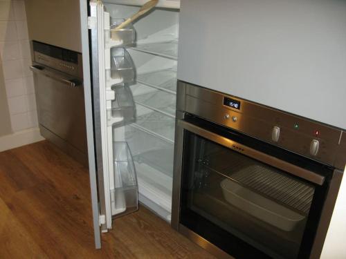 a refrigerator with its door open in a kitchen at Studio/Patio pour 3 hypercentre! in Le Touquet-Paris-Plage
