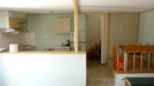 a kitchen and dining room with a table and a counter top at Soubassis House in Elíka