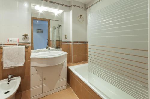 a bathroom with a sink and a tub and a toilet at Alejandrita in Playa de Gandia