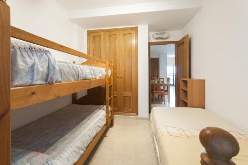 a bedroom with two bunk beds and a hallway at Alejandrita in Playa de Gandia