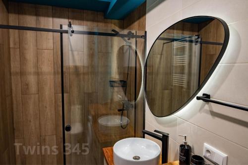 a bathroom with a shower and a sink and a mirror at Valley & Mountain View, Twins, with Hot Water in Gudauri