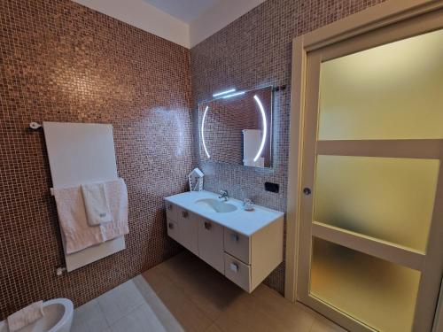 a bathroom with a sink and a mirror at Polignano a Mare: sulla piazza di Domenico Modugno in Polignano a Mare