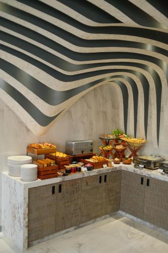 a buffet line with food on top of it at Hotel Ocean Grand at Hulhumale in Hulhumale