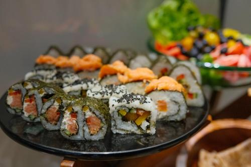 a plate of sushi on top of a table at Hotel Ocean Grand at Hulhumale in Hulhumale