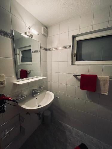 a white bathroom with a sink and a mirror at Haus Thurner in Rifenal