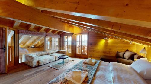 a bedroom with a large bed in a wooden room at Terrasses du Paradis 7A LUXE & CENTER apart 8 pers in Nendaz