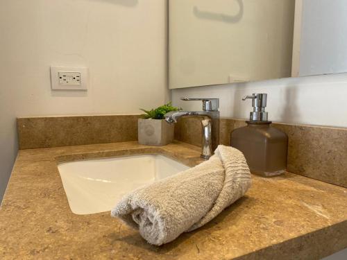 a bathroom sink with a towel on a counter at Apartamento Park Way Bogotá in Bogotá