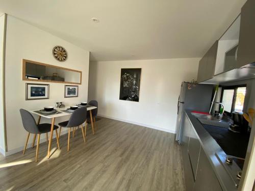 a kitchen and living room with a table and chairs at Apartamento Park Way Bogotá in Bogotá