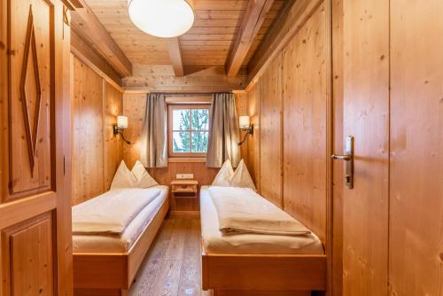 a small room with two beds in a cabin at Almwelt Austria in Schladming