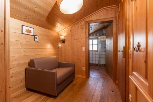 a room with a chair in a wooden room at Almwelt Austria in Schladming