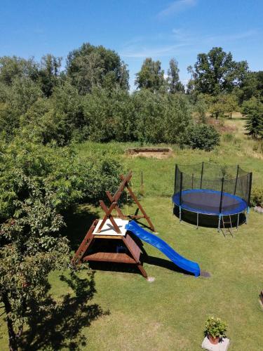a playground with a slide and a trampoline at Slunečnice - Ubytování v soukromí na Třeboňsku in Třeboň
