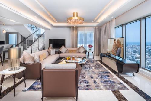 a living room with a couch and a table at Somerset Downtown Al Khobar in Al Khobar