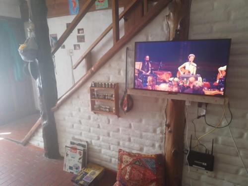 a flat screen tv hanging on a wall at Casa SMA in San Martín de los Andes