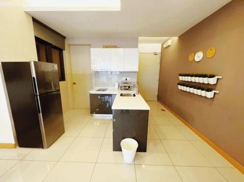 a kitchen with a stainless steel refrigerator and a counter at [PROMO]Connected train 2 Bedroom (ABOVE MALL)15 in Kuala Lumpur