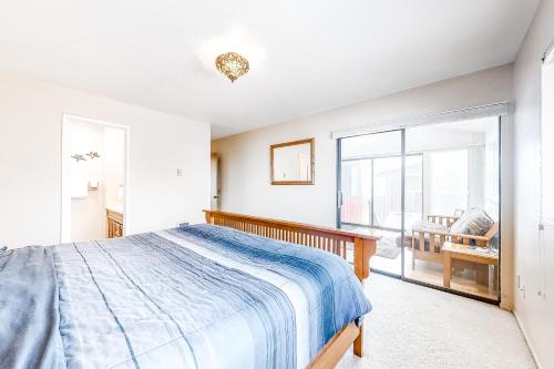 a bedroom with a bed and a large window at Tidal Links - 4 Bed 3 Bath Vacation home in Bandon Dunes in Bandon