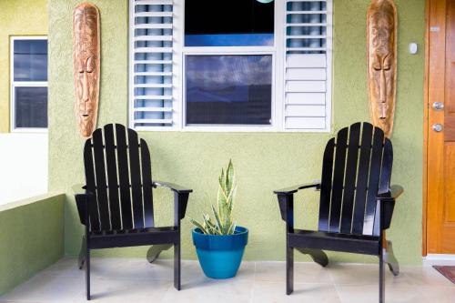 two chairs sitting outside of a house with a plant at Ocho Rios Casa Princess Vacay Villa in Ocho Rios