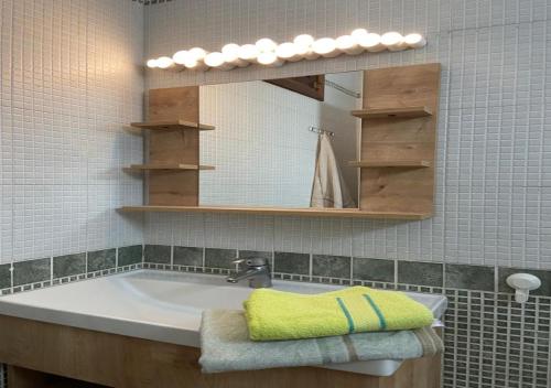 a bathroom with a sink and a mirror at Mi Casa Jardins de Cabo Negro in Cabo Negro