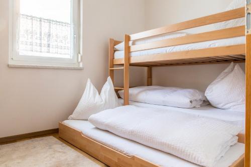 two bunk beds in a room with a window at Ferienhaus Schlagerbauer Biohof in Salzburg
