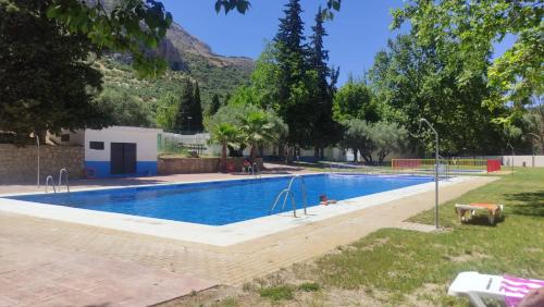 una piscina in un cortile con una montagna sullo sfondo di Casa Fina ad Albanchez de Úbeda