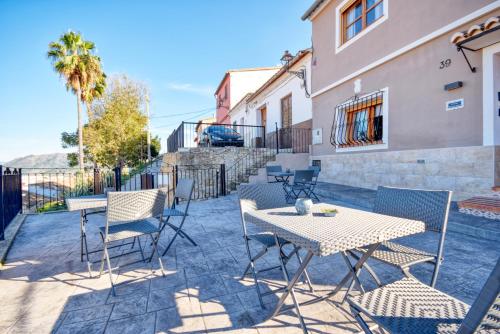 a patio with a table and chairs and a building at Casa Millor Vista, Rooms in Xàtiva