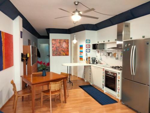 a kitchen with a table and a refrigerator at SeaSide in Giardini Naxos