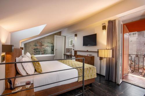 a hotel room with a bed and a balcony at Navona Essence Hotel in Rome