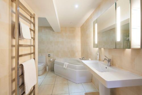 La salle de bains est pourvue d'une baignoire, d'un lavabo et de toilettes. dans l'établissement The Priory Hotel, à Beauly
