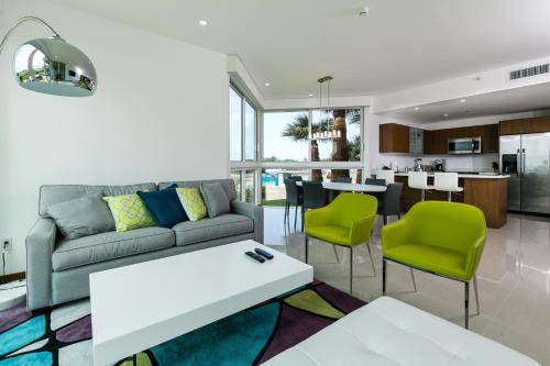 a living room with a couch and a table at Blue Residences in Palm-Eagle Beach