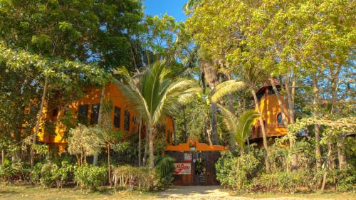 a house with a palm tree in front of it at Hostería Ecológica El Faro in Salinas