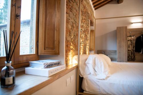 a bedroom with a bed and books on a counter at Villa Barberino in Meleto